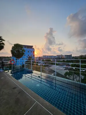 a swimming pool on the roof of a building at La Xenia Hotel Kata Beach in Kata Beach