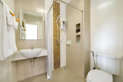 a bathroom with a toilet and a sink and a shower at The Topaz Residence Phuket Town in Phuket Town