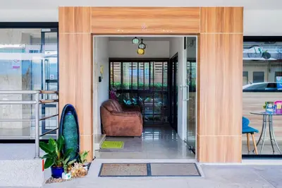 a lobby with a couch and a chair in a building at The Topaz Residence Phuket Town in Phuket Town