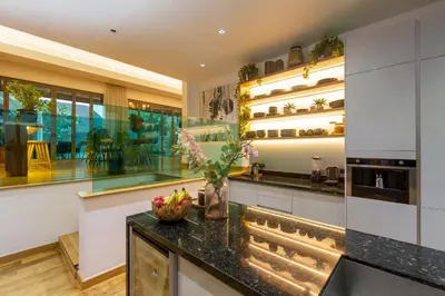 a kitchen with a counter with a bowl of fruit on it at Stunning 5BR villa with freshwater pool & tropical garden in Ban Phru Champa