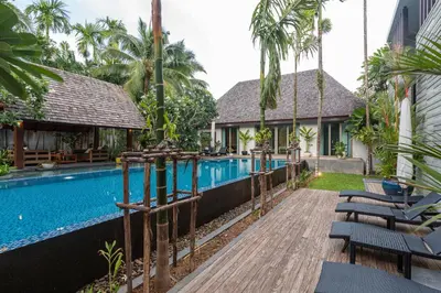 a resort with a swimming pool and a resort at Stunning 5BR villa with freshwater pool & tropical garden in Ban Phru Champa