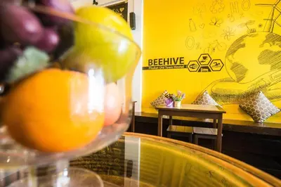 an orange in a wine glass in a restaurant at Beehive Phuket Old Town Hostel in Phuket Town