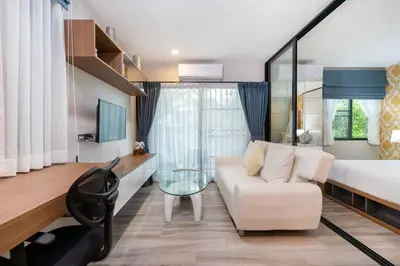 a living room with a bed and a couch and a room with a bed at Nayang Beach Brand New Executive Luxury Condo in Nai Yang Beach