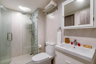 a bathroom with a toilet and a sink and a shower at Nayang Beach Brand New Executive Luxury Condo in Nai Yang Beach