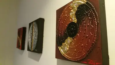 two pieces of art hanging on a wall at Green House Phuket in Ban Pa Khlok