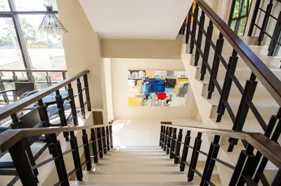 a staircase in a house with a painting on the wall at Naka Residence in Phuket Town