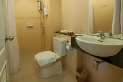a bathroom with a sink and a toilet at Naka Residence in Phuket Town