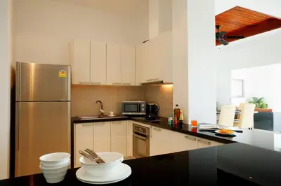 a kitchen with a refrigerator and a counter top at Phuket Kamala, Spectacular Seaviews, Private pool, 3 BR in Kamala Beach