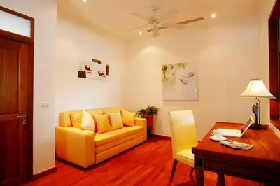 a living room with a yellow couch and a table at Phuket Kamala, Spectacular Seaviews, Private pool, 3 BR in Kamala Beach