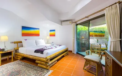 a bedroom with a bed and a large window at Luxury Four Bed Villa Jasmine, infinity pool, full staff , chef and breakfasts in Kata Beach