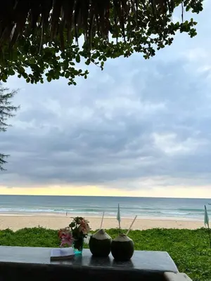 a table with a view of the beach at Sealord Naithon Beachfront Villa in Nai Thon Beach