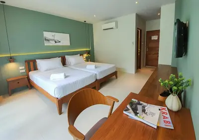 a hotel room with a bed and a table with a table sidx sidx at Mini House Aonang Hotel SHA Plus in Ao Nang Beach