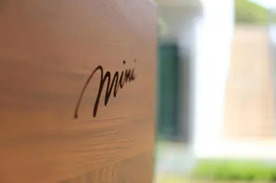 a close up of a wooden door with a sound at Mini House Aonang Hotel SHA Plus in Ao Nang Beach