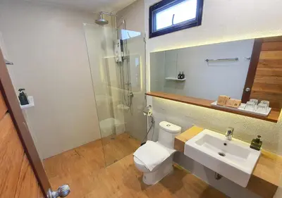 a bathroom with a toilet and a sink and a shower at Mini House Aonang Hotel SHA Plus in Ao Nang Beach