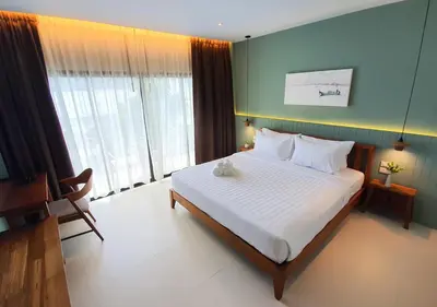 a bedroom with a large bed and a large window at Mini House Aonang Hotel SHA Plus in Ao Nang Beach