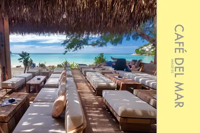 a row of chaise lounges on the beach at Tranquil Condo close to Beach in Kamala Beach