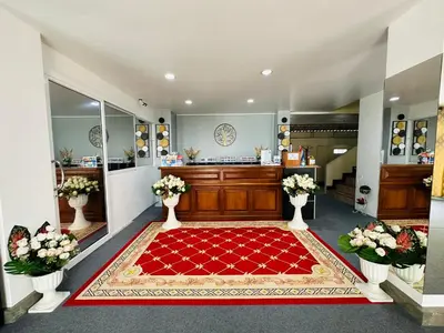 a large room with a red rug on the floor at Kata Place Hotel in Kata Beach