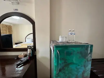 a room with a mirror and an aquarium in a room at Kata Place Hotel in Kata Beach