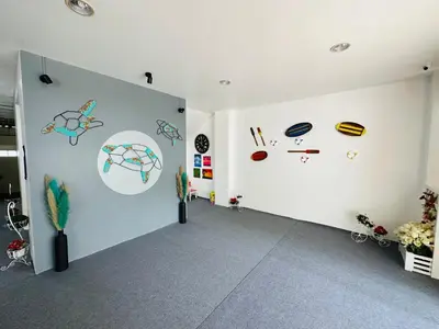 a room with white walls with drawings on the wall at Kata Place Hotel in Kata Beach