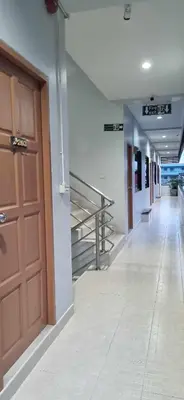 an empty hallway with a door and stairs in a building at ก้านกล้วยแมนชั่น Gankluy Mansion in Phuket Town