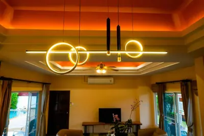 a chandelier hanging from a ceiling in a living room at Luxurious large size swimming pool villa in Rawai in Ban Saiyuan (1)