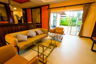 a living room with a yellow couch and two chairs at Luxurious large size swimming pool villa in Rawai in Ban Saiyuan (1)