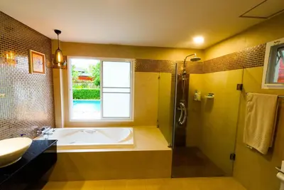 a bathroom with a tub and a sink and a window at Luxurious large size swimming pool villa in Rawai in Ban Saiyuan (1)