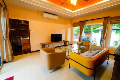 a living room with a couch and a table at Luxurious large size swimming pool villa in Rawai in Ban Saiyuan (1)