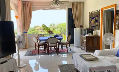 a living room with a blue table and chairs at OASIS VILLA Karon Beach in Karon Beach