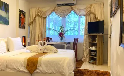 a bedroom with a bed with a stuffed animal on it at OASIS VILLA Karon Beach in Karon Beach