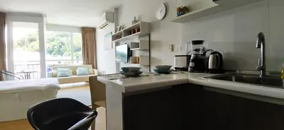 a kitchen with a sink and a counter top at Kata Beach OZONE Superb Fully Equipped studio kitchen washing machine air con in Kata Beach