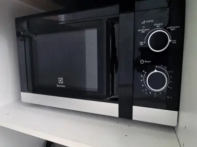 a microwave oven sitting on top of a counter at Kata Beach OZONE Superb Fully Equipped studio kitchen washing machine air con in Kata Beach