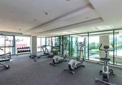 a gym with several treadmills and cardio machines at Patong - The Unity Seaview & Mountain Residence in Patong Beach
