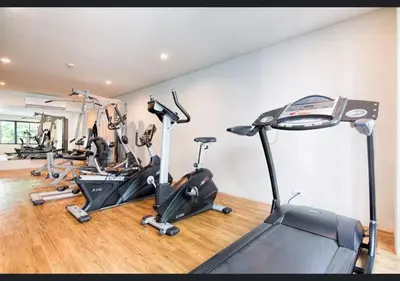 a gym with several treadmills and exercise bikes at Patong - The Unity Seaview & Mountain Residence in Patong Beach