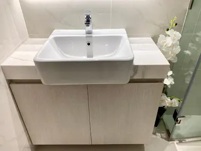 a white sink in a bathroom with white tiles at Laguna cassia residences in Bang Tao Beach