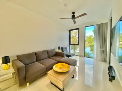 a living room with a couch and a table at Laguna cassia residences in Bang Tao Beach