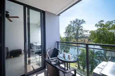 a room with a balcony with a table and chairs at Laguna cassia residences in Bang Tao Beach