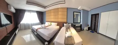 a bedroom with two beds in a room with a window at La Piccola Kata in Kata Beach