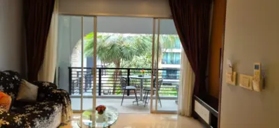 a living room with a couch and a table on a balcony at La Piccola Kata in Kata Beach