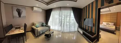 a living room with a chair and a window at La Piccola Kata in Kata Beach