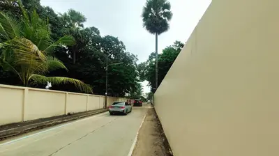 a car parked on the side of a road with a palm tree at Casuarina Shores Apartment - SHA Plus in Bang Tao Beach