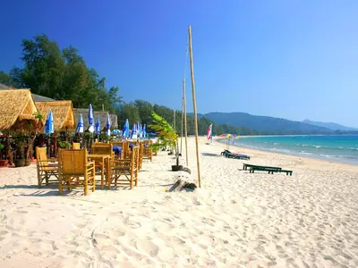 a group of chairs and umbrellas on a beach at Casuarina Shores Apartment - SHA Plus in Bang Tao Beach