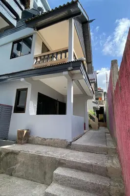 a white house with stairs in front of it at The dream garden in Ao Nang Beach