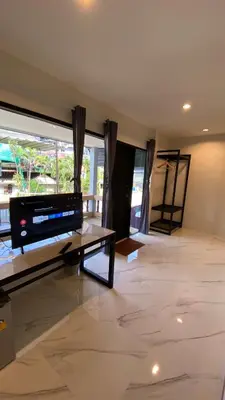 a living room with a tv and a large window at The dream garden in Ao Nang Beach