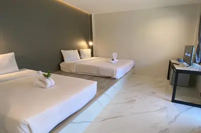 a hotel room with two beds and a television at The dream garden in Ao Nang Beach