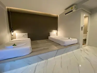 two beds sitting in a room with at The dream garden in Ao Nang Beach