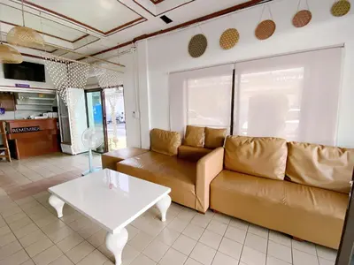 a living room with a couch and a table at Remember at Phuket Town Hostel in Phuket Town