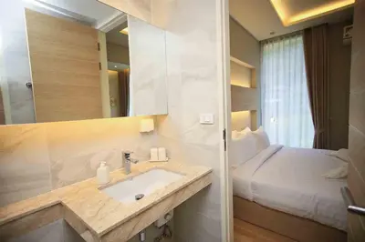 a bathroom with a sink and a bed in a room at Apartment in Aonang - great location with pool in Ao Nang Beach