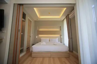 a bedroom with a large white bed and a window at Apartment in Aonang - great location with pool in Ao Nang Beach