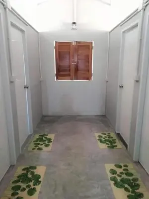 an empty room with two doors and a window at Farm House kohyaoyai in Ko Yao Yai